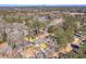 An aerial view shows the house with its fenced backyard in a tree-filled neighborhood at 2569 Woodhill Ln, Atlanta, GA 30344