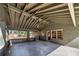 Covered back patio with brick support columns, exposed rafters, and a hanging light at 2569 Woodhill Ln, Atlanta, GA 30344