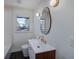 Bright bathroom featuring a modern vanity and black tiled floor with modern oval mirror at 2569 Woodhill Ln, Atlanta, GA 30344