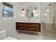 Modern bathroom with floating vanity, stylish lighting, and glass-enclosed shower at 2569 Woodhill Ln, Atlanta, GA 30344