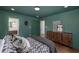 Stylish bedroom with hardwood floors, green walls, and modern furnishings including a dresser at 2569 Woodhill Ln, Atlanta, GA 30344