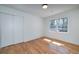 Clean bedroom featuring hardwood floors, a closet, and natural light from two windows at 2569 Woodhill Ln, Atlanta, GA 30344