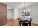 Dining area with hardwood floors, statement lighting fixture, and views to the outdoors at 2569 Woodhill Ln, Atlanta, GA 30344