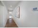 Bright hallway featuring hardwood floors, white walls, and modern decor at 2569 Woodhill Ln, Atlanta, GA 30344