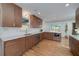 Well-lit kitchen featuring stainless steel appliances, hardwood floors, marble countertops, and custom cabinets at 2569 Woodhill Ln, Atlanta, GA 30344