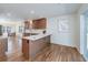 Open-concept kitchen featuring a breakfast bar, modern appliances, and hardwood floors at 2569 Woodhill Ln, Atlanta, GA 30344