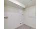 A simple laundry area features tiled floors and connections for a washer and dryer at 2569 Woodhill Ln, Atlanta, GA 30344