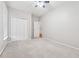 Large bedroom features neutral carpet, fan, a window, and closet space at 6491 Stonelake Sw Pl, Atlanta, GA 30331