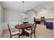 Dining area features hardwood floors, a wooden table, and a charming light fixture at 6491 Stonelake Sw Pl, Atlanta, GA 30331