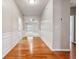 Inviting foyer with wood floors and wainscoting, leading to an open living area with a ceiling fan at 6491 Stonelake Sw Pl, Atlanta, GA 30331