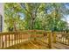 Wooden deck and railing, surrounded by lush trees, creates a private outdoor space at 891 Thurmond Nw St, Atlanta, GA 30314