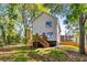 An exterior shot of the rear of the house with a wooden deck overlooking a grassy lawn at 891 Thurmond Nw St, Atlanta, GA 30314