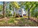 Backyard view of home, featuring a deck with stairs and a partial fence on a lush lot at 891 Thurmond Nw St, Atlanta, GA 30314