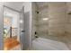 Modern bathroom featuring a bathtub with gray tiled walls and matte black plumbing fixtures at 891 Thurmond Nw St, Atlanta, GA 30314