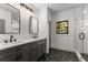 Modern bathroom features a double vanity with quartz countertop, tile flooring, and a glass-enclosed shower at 891 Thurmond Nw St, Atlanta, GA 30314