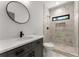 Modern bathroom features a sleek vanity with quartz countertop, walk-in shower with marble tile, and black finishes at 891 Thurmond Nw St, Atlanta, GA 30314