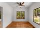 Bright bedroom featuring hardwood floors, ceiling fan, and two windows providing ample natural light and views at 891 Thurmond Nw St, Atlanta, GA 30314