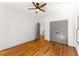 This bedroom features hardwood floors, a ceiling fan and gray closet doors at 891 Thurmond Nw St, Atlanta, GA 30314