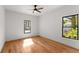 Bedroom with hardwood floors, two windows letting in natural light, and ceiling fan at 891 Thurmond Nw St, Atlanta, GA 30314