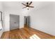 This bedroom features hardwood floors, a ceiling fan and gray closet doors at 891 Thurmond Nw St, Atlanta, GA 30314