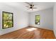 Bedroom featuring hardwood floors, neutral walls, ceiling fan, and two windows for ample light at 891 Thurmond Nw St, Atlanta, GA 30314