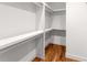 Walk-in closet with custom shelving and hardwood floors, offering ample storage space at 891 Thurmond Nw St, Atlanta, GA 30314