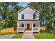 Charming two-story home featuring a welcoming front porch, fresh landscaping, and a classic white facade at 891 Thurmond Nw St, Atlanta, GA 30314