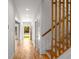 Hallway with hardwood floors, staircase with wooden railing, and natural light filtering through a window at 891 Thurmond Nw St, Atlanta, GA 30314