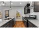 Modern kitchen with granite counters, stainless steel appliances, dark wood cabinets, and hardwood floors at 891 Thurmond Nw St, Atlanta, GA 30314