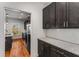 Contemporary kitchen design featuring granite counters, dark cabinets with gold hardware, subway tile backsplash, and stainless appliances at 891 Thurmond Nw St, Atlanta, GA 30314