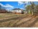 Spacious backyard with mature trees surrounding the property at 1450 Brandy Shoals Se Dr, Conyers, GA 30013