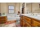 Bathroom features a tub, sink, and wood cabinets at 1450 Brandy Shoals Se Dr, Conyers, GA 30013