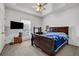 Cozy bedroom features a dark wood bed frame, carpet, and a ceiling fan at 1450 Brandy Shoals Se Dr, Conyers, GA 30013