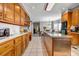 Galley kitchen featuring tile floors, wooden cabinets, stainless steel appliances, and an island at 1450 Brandy Shoals Se Dr, Conyers, GA 30013