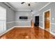 Bright living room with hardwood floors, light gray walls, and views into the kitchen and other rooms at 1450 Brandy Shoals Se Dr, Conyers, GA 30013