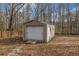 Exterior view of storage shed with door and surrounding landscape at 1450 Brandy Shoals Se Dr, Conyers, GA 30013