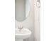 Close-up of bathroom sink with modern faucet and round mirror at 2025 Wyndham Pl, Conyers, GA 30013