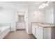 Bright bathroom with double vanities, white cabinets, granite countertops, and modern lighting at 2025 Wyndham Pl, Conyers, GA 30013