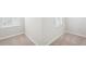 Bedroom featuring neutral carpet, white walls, base trim, and a window at 2025 Wyndham Pl, Conyers, GA 30013