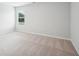 Bedroom featuring neutral carpet, white walls, one window, and base trim at 2025 Wyndham Pl, Conyers, GA 30013