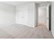 Bright bedroom with neutral carpet, white walls, closet, and doorway to hallway at 2025 Wyndham Pl, Conyers, GA 30013