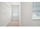 Walk-in closet features a wire shelf, neutral carpet and a window at 2025 Wyndham Pl, Conyers, GA 30013