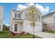Two-story home with a two-car garage, and a well manicured front yard at 2025 Wyndham Pl, Conyers, GA 30013