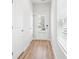 Hallway featuring wood floors, white walls and trim, and a view of the front door at 2025 Wyndham Pl, Conyers, GA 30013