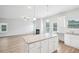 Bright kitchen with a granite island adjacent to the living room with a fireplace creates a connected living space at 2025 Wyndham Pl, Conyers, GA 30013