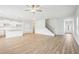 Open-concept living room with bright, white walls and wood-look floors at 2025 Wyndham Pl, Conyers, GA 30013