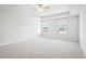 Spacious primary bedroom with carpeted floors, two windows, and a trey ceiling, creating a relaxing retreat at 2025 Wyndham Pl, Conyers, GA 30013