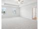 Spacious primary bedroom with carpeted floors, two windows, and a trey ceiling, creating a relaxing retreat at 2025 Wyndham Pl, Conyers, GA 30013