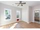 Well-lit bedroom featuring hardwood floors, a ceiling fan, two windows, and closet at 3286 Bachelor St, East Point, GA 30344