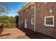View of the back of the red brick house with access to the backyard at 4837 Mystere Cir, Lilburn, GA 30047